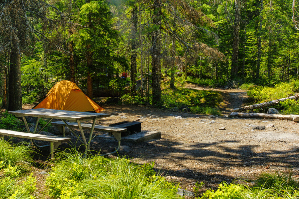 camp ground with yellow tent and picnic table